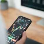 a person holding a cell phone in their hand