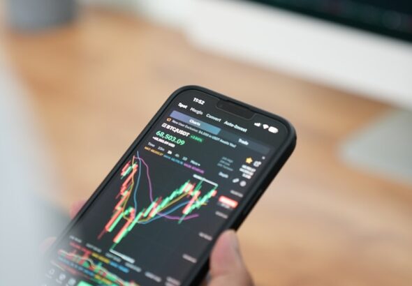 a person holding a cell phone in their hand