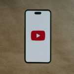 a white phone with a red youtube logo on it