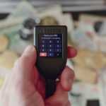 a person holding a cell phone in their hand