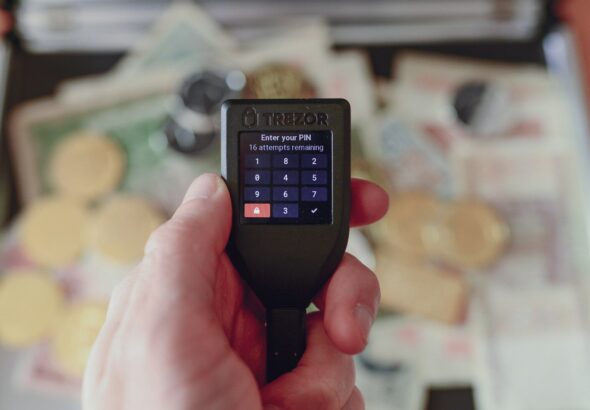 a person holding a cell phone in their hand